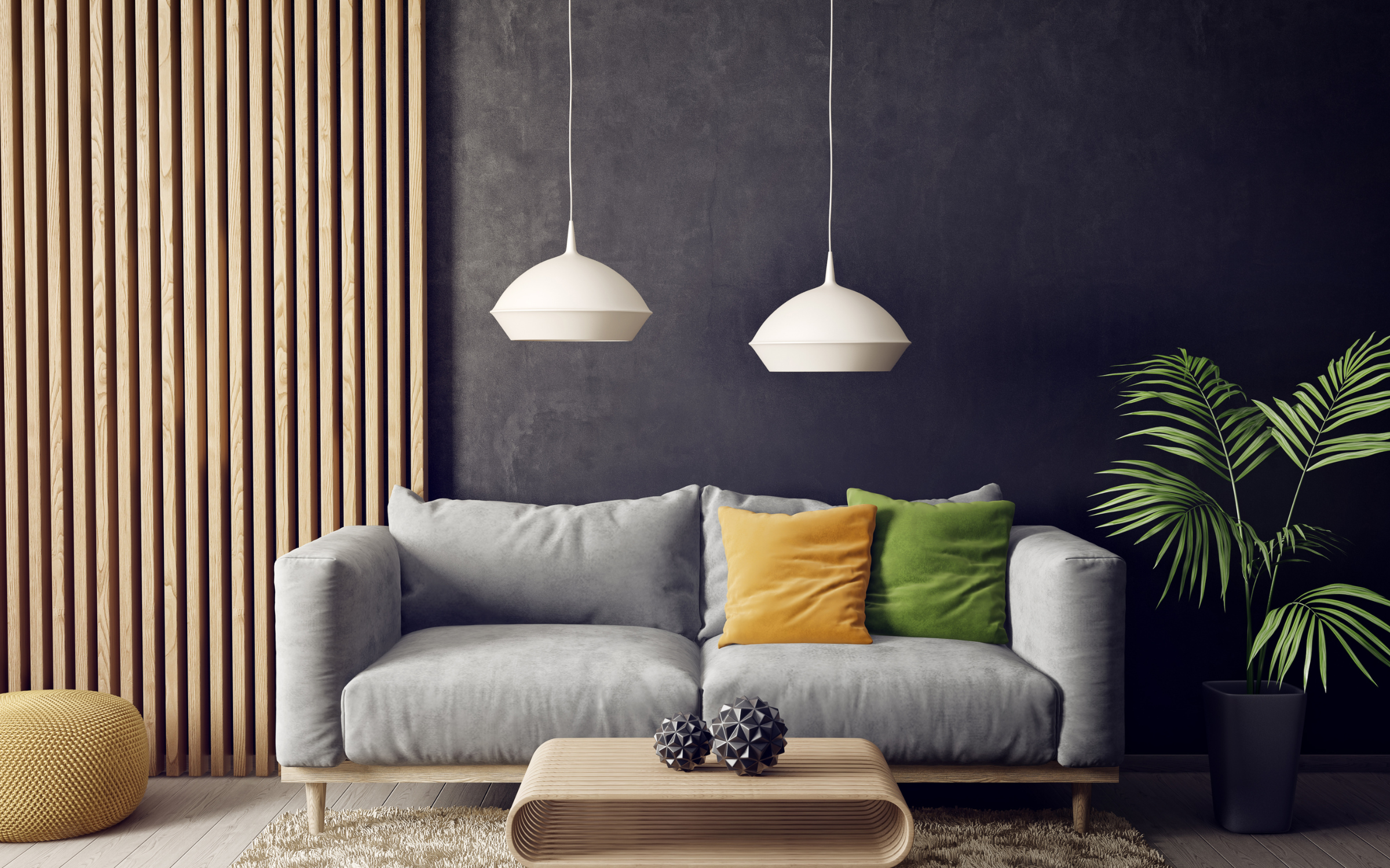A set of living room furniture complete with a gray couch, a modern wooden coffee table, two hanging lights, and an indoor plant.